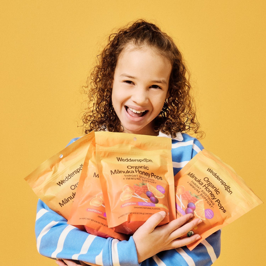 Girl holding organic manuka honey pops